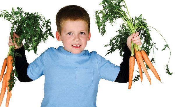 Boy holding carrots